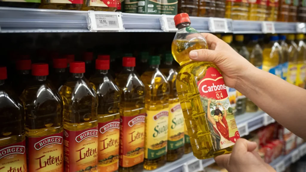 A person holds a bottle of olive oil on June 21, 2024, in Barcelona, ​​Catalonia, Spain.